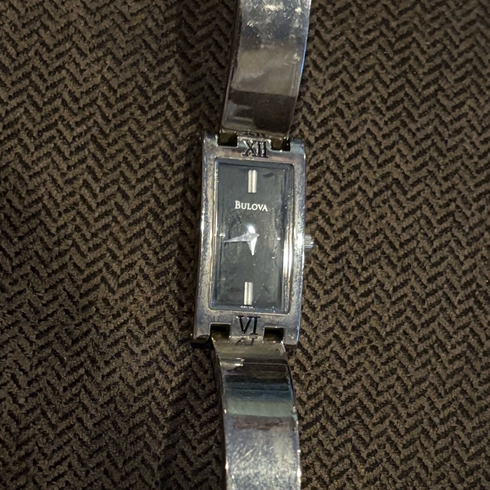Bulova Silver Wearable Watch with black watch face silver hands Roman numerals